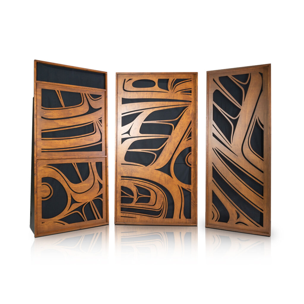 Three wooden screens with intricate black abstract designs, each set against a white background.